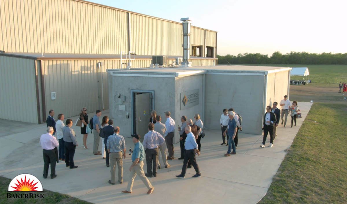 Aerial view of tour group visiting FORTRESS Nameplate #1 building.