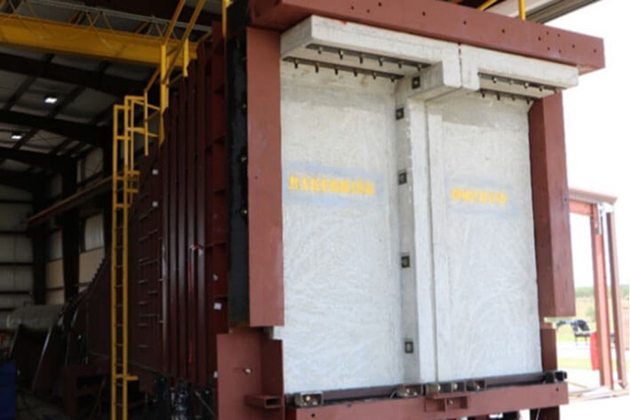 A reinforced concrete wall panel in a test frame for testing blast resistance.