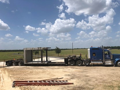 A permanent modular building on a transport truck.