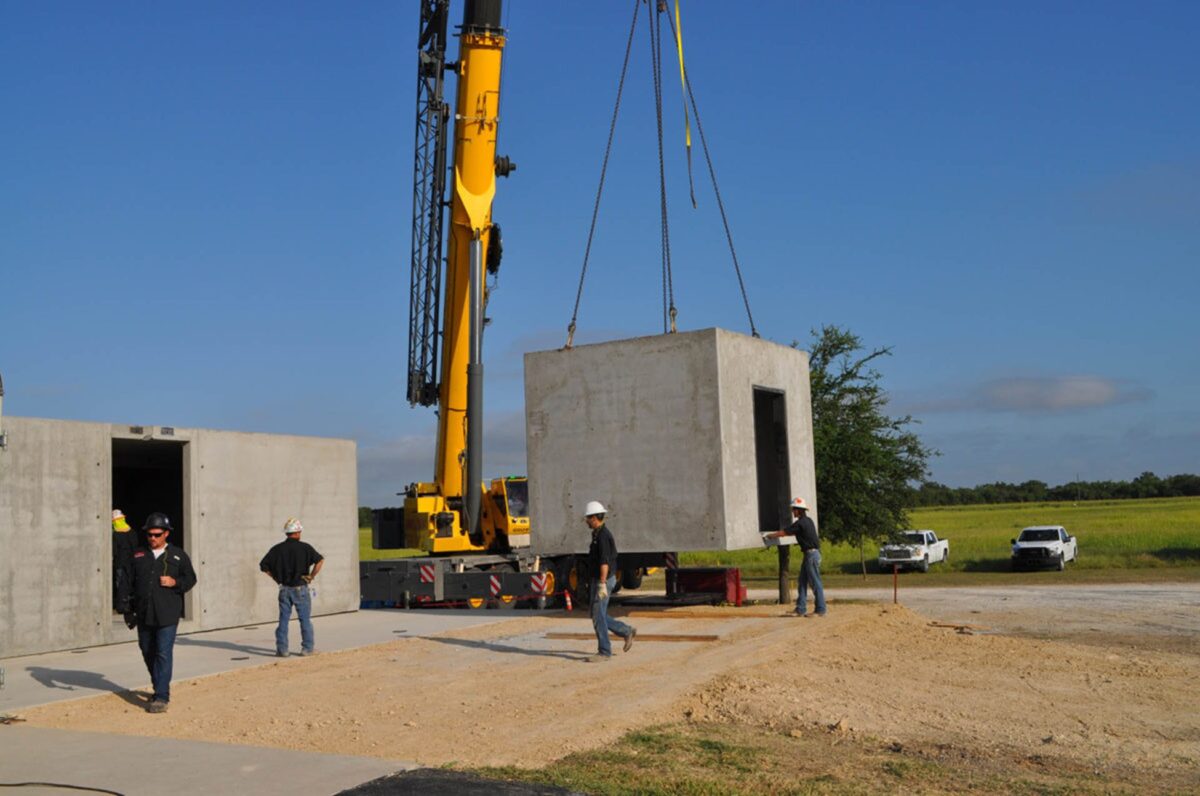 The module of a permanent modular building being lifted and placed by a crane for installation.