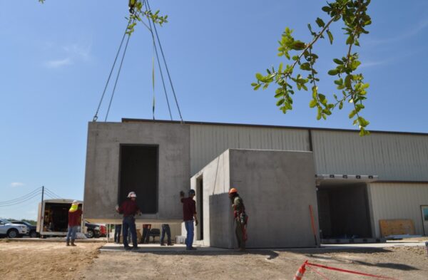 Workers installing a concrete disaster resilient building