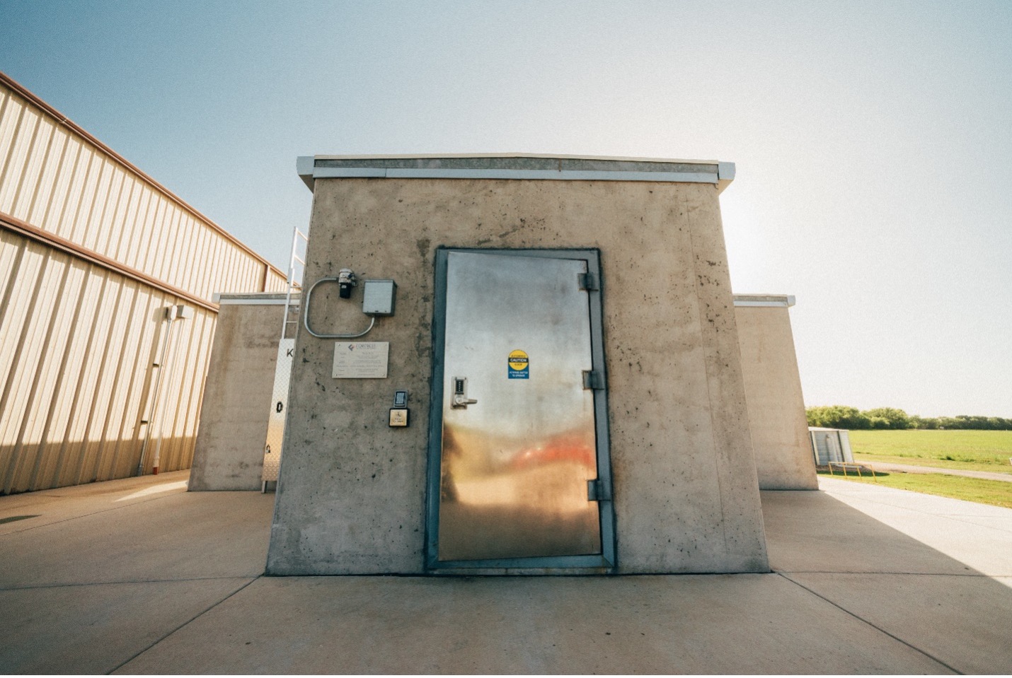 A blast resistant precast concrete building with blast and fire-resistant door