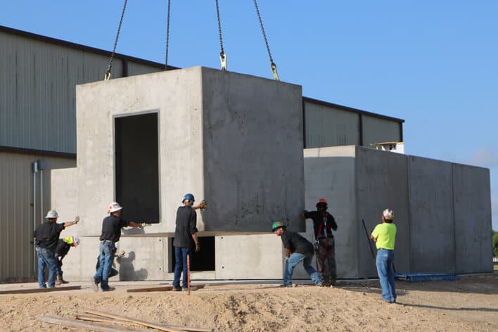 Workers installing the modules of a blast resistant structure.